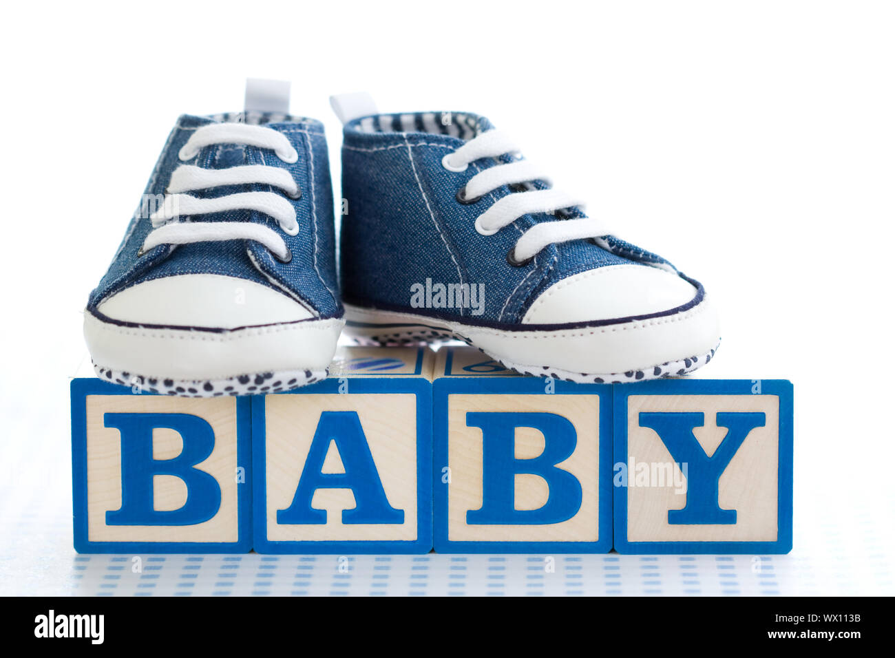 Baby blocks with denim baby shoes Stock Photo - Alamy