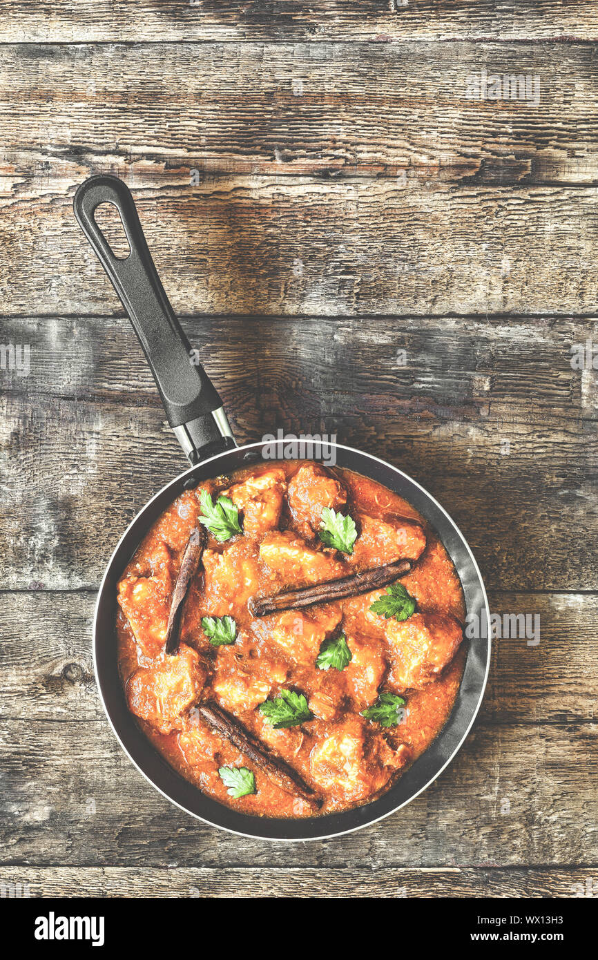 Chicken Curry. curry, chicken, frying pan, coriander, cinnamon sticks. Indian food. Stock Photo