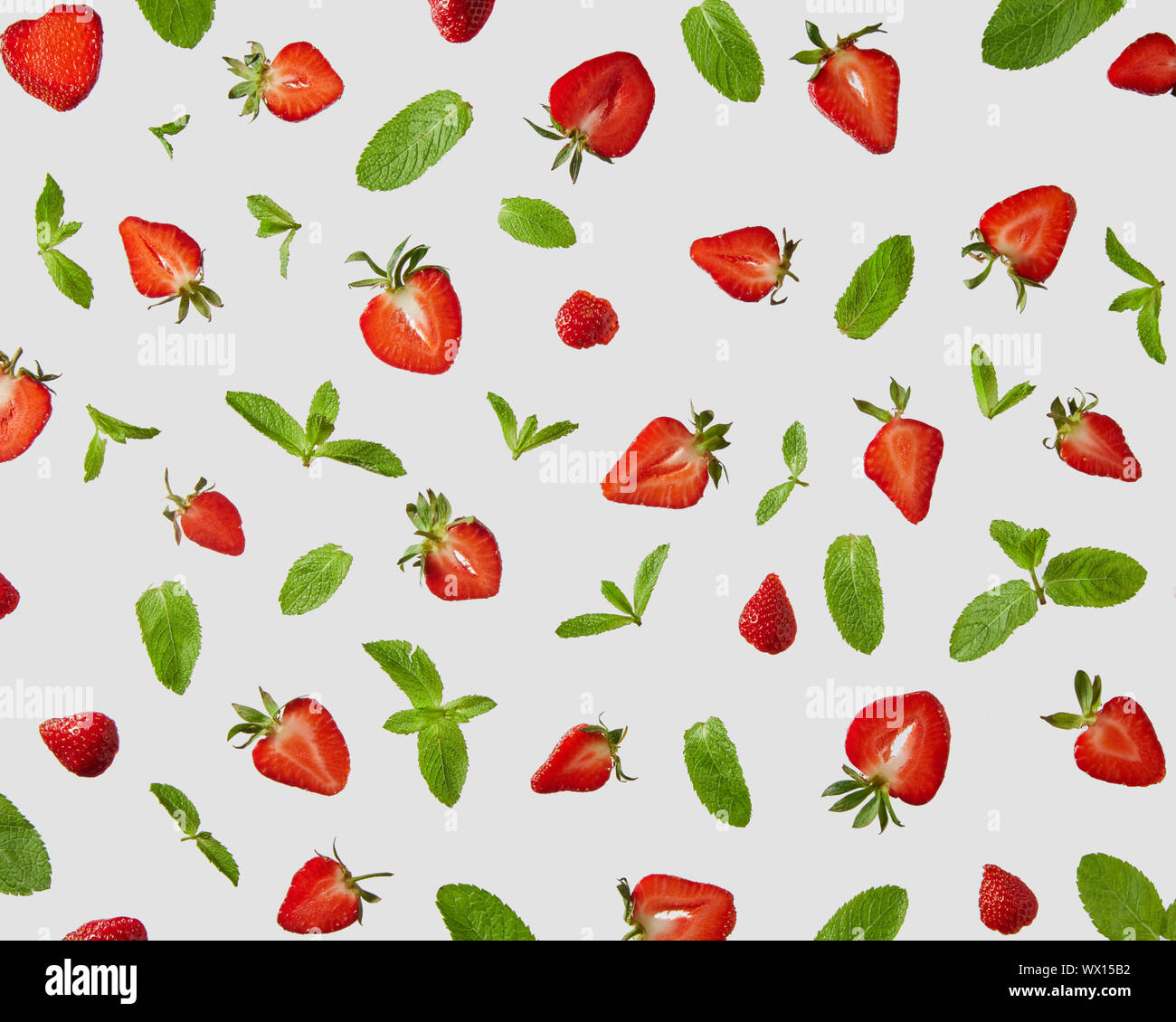 Strawberry and mint leaves isolated on gray background. Creative food concept Stock Photo