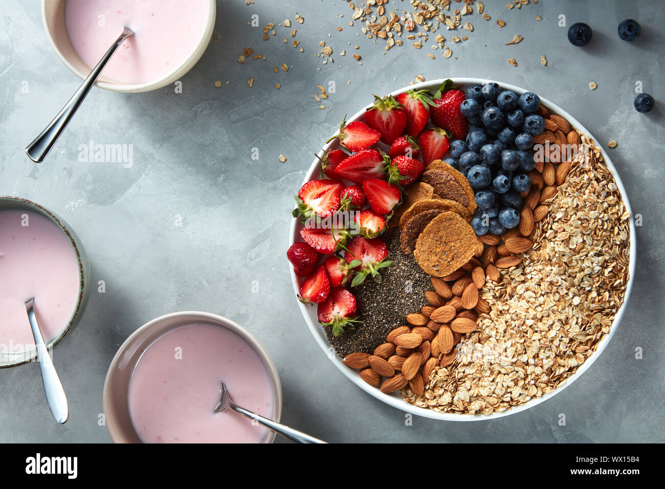 yogurt in glasses with granola, berries and chia seeds for healthy