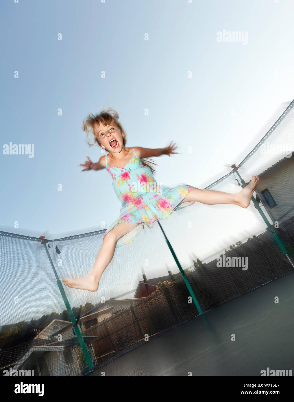 Young Girl Jumping in a trampoline Stock Photo - Alamy