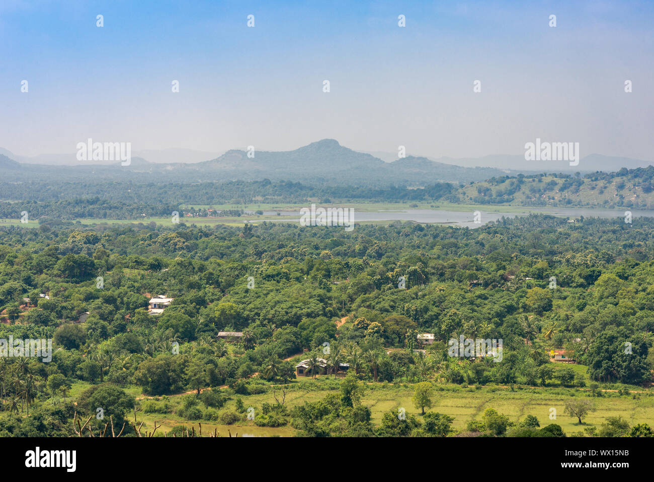 View from the Dambulla cave temple to the countryside with mountains, woodland and paddy fields Stock Photo