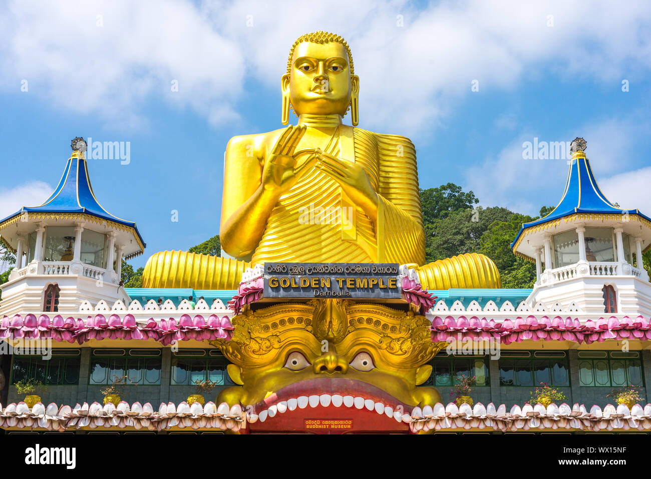 Huge golden Buddha statue on top of the Buddhist Museum of the Golden Temple Dambulla Stock Photo