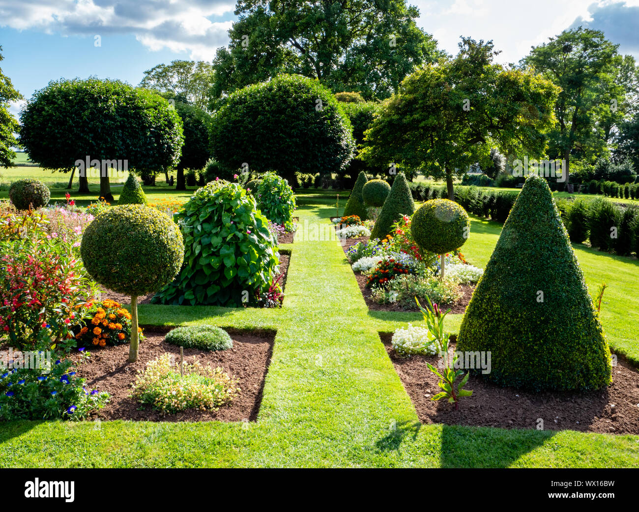 Topiary and flower parterre at Wesbury Court Garden a 17th century Dutch style water garden at Westbury on Severn Gloucestershire UK Stock Photo