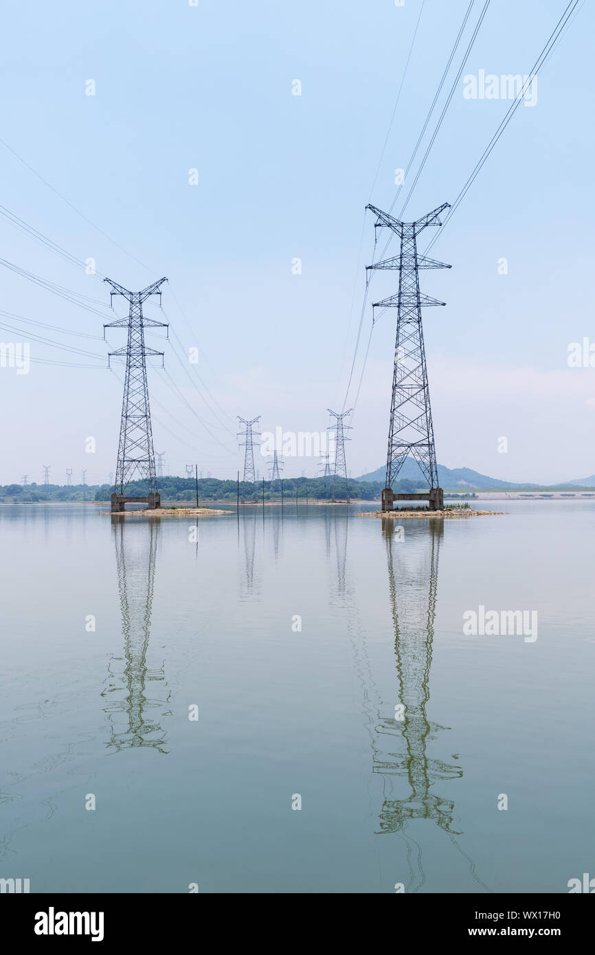 electricity pylon on lake Stock Photo