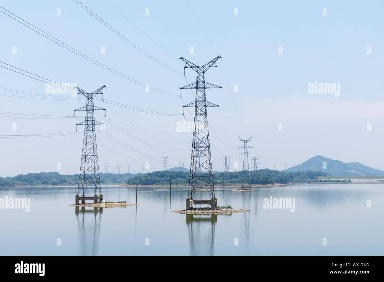 electricity pylon on lake Stock Photo
