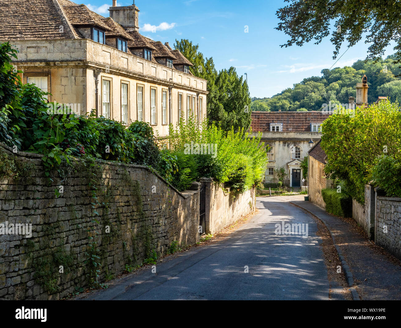 Small manor house and other grand buildings on a street in Freshford village near Bath in Somerset UK Stock Photo