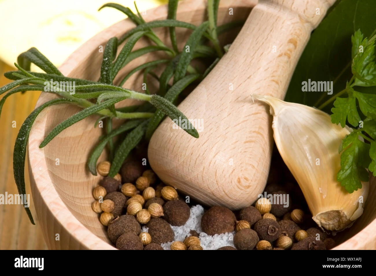 Mortar with fresh herbs and allspice berries Stock Photo Alamy