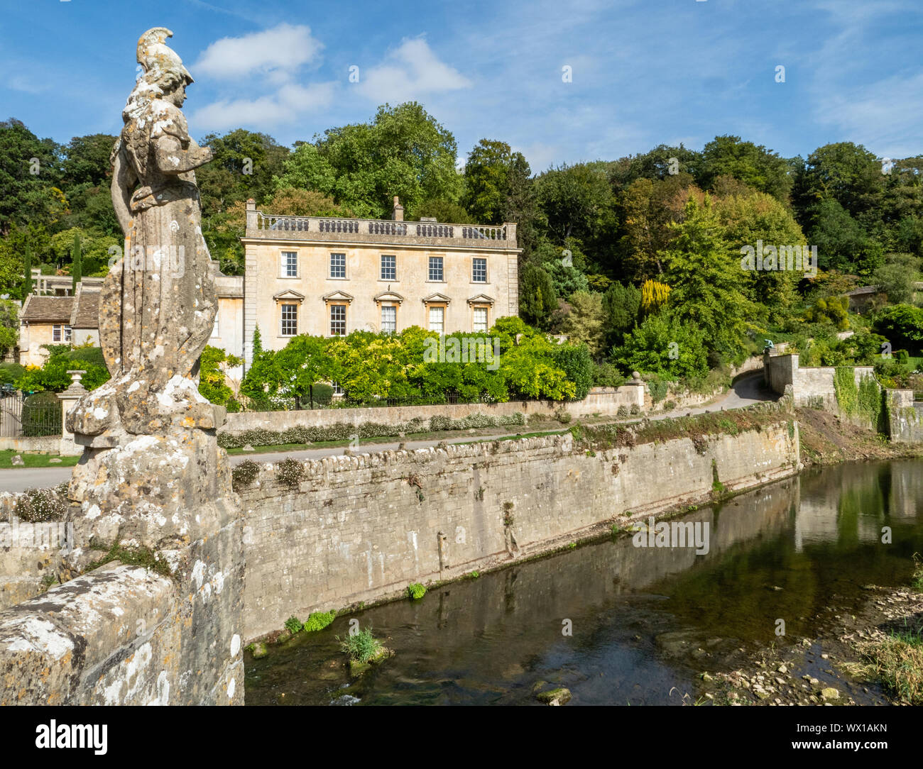 Statue of Britannia on the river bridge leading to Iford Manor a charming country house in the Frome Valley in Wiltshire UK Stock Photo