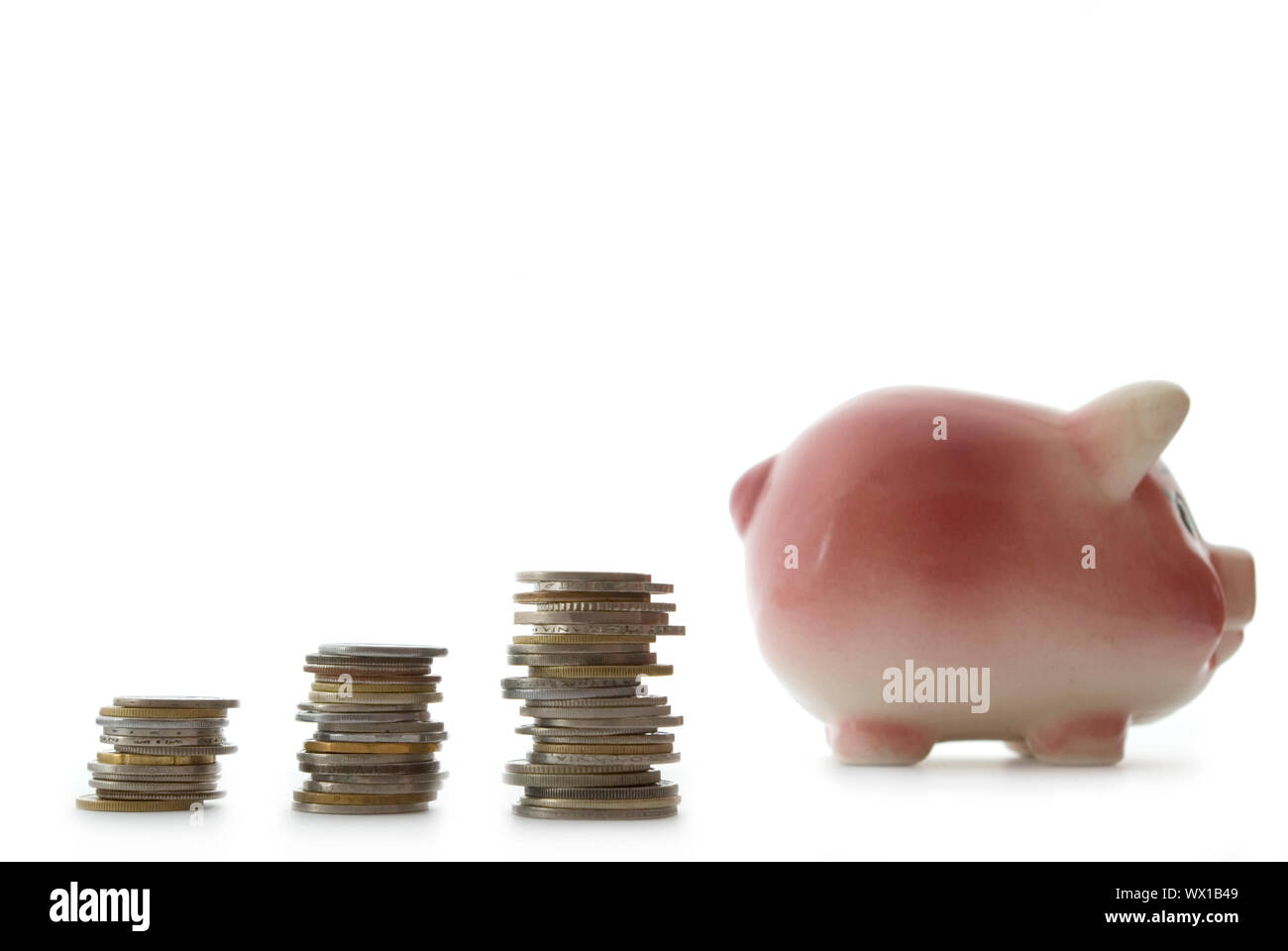Pink piggy bank isolated on white background with coins Stock Photo - Alamy