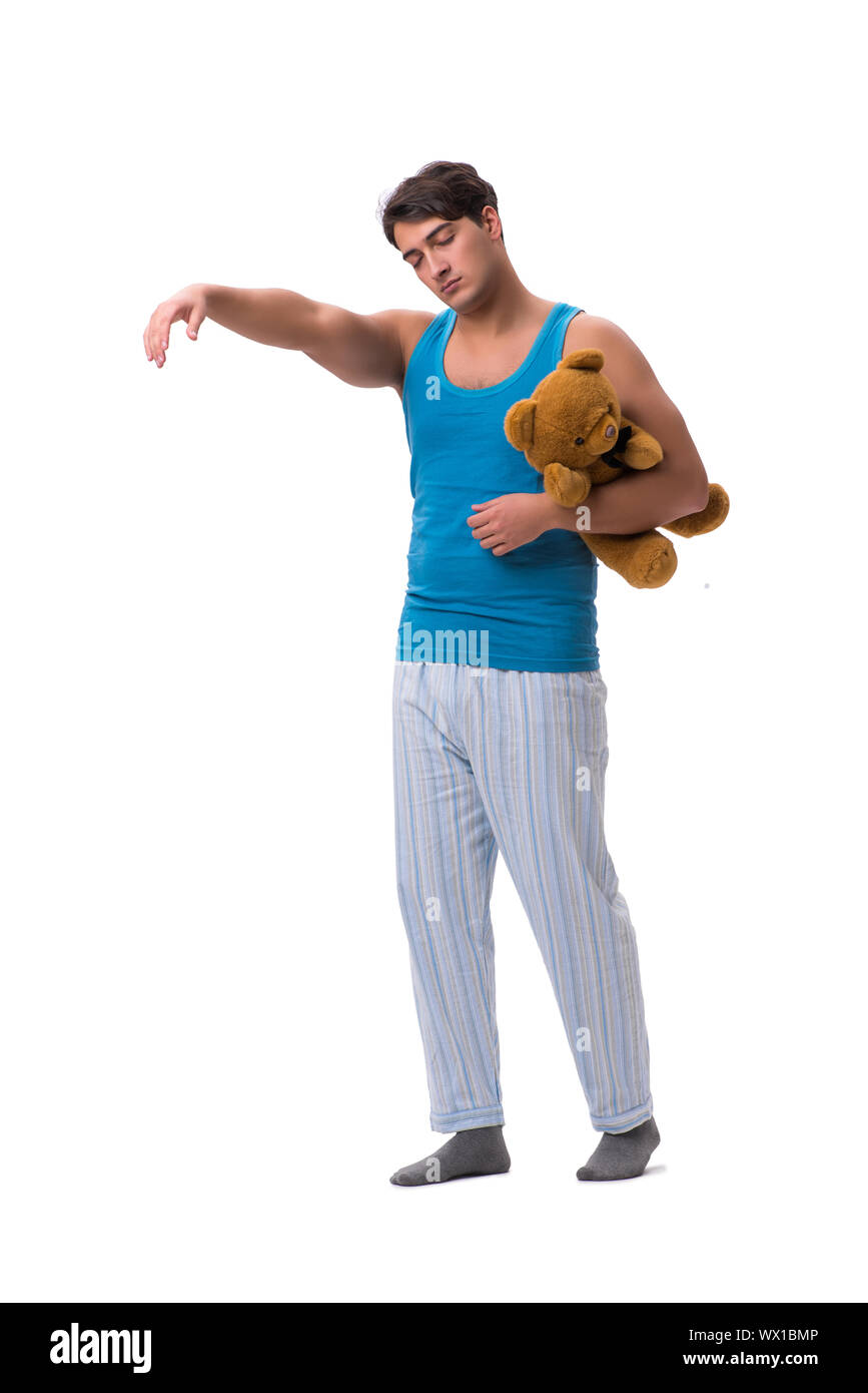 Young man in pajamas with toy animal isolated on white backgroun Stock Photo