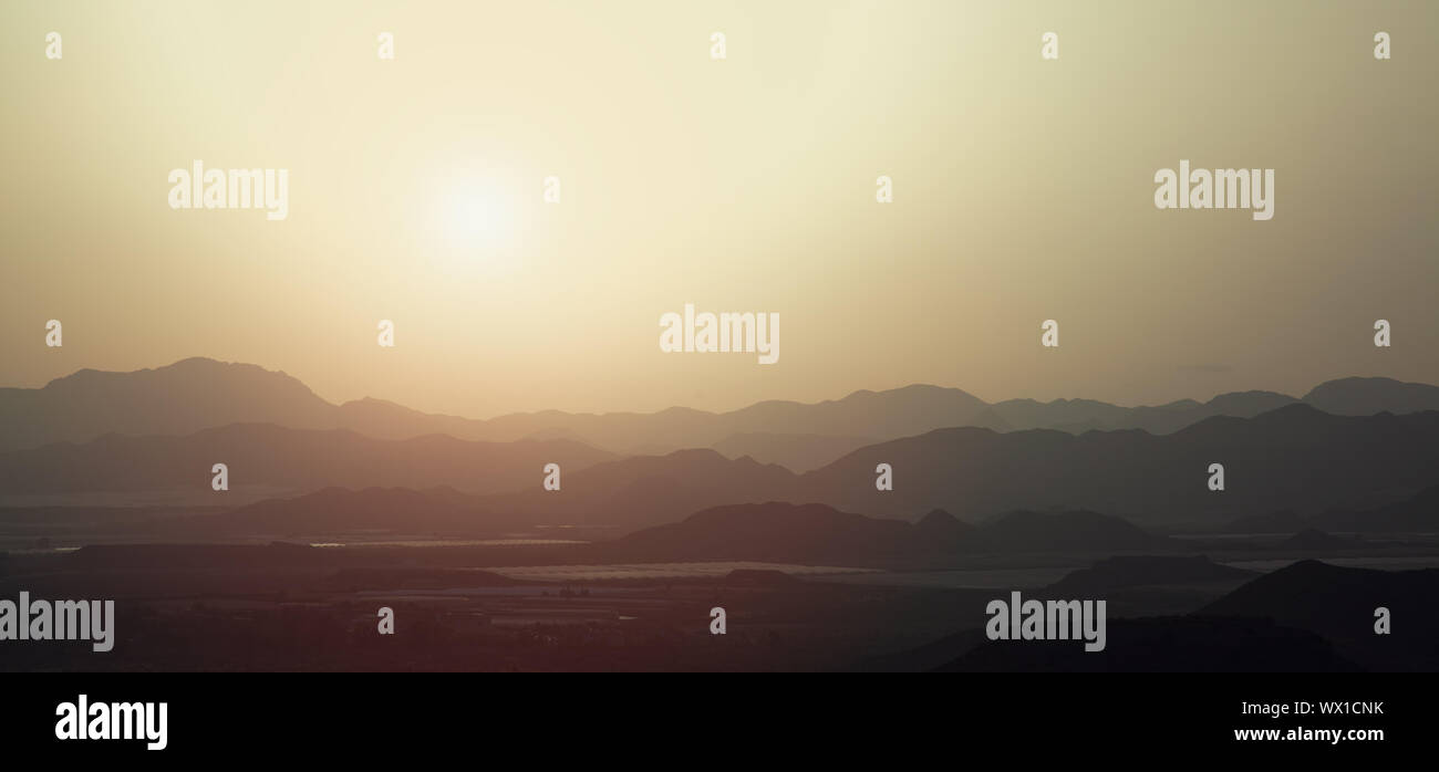the silhouette of the mountains at sunset Stock Photo - Alamy