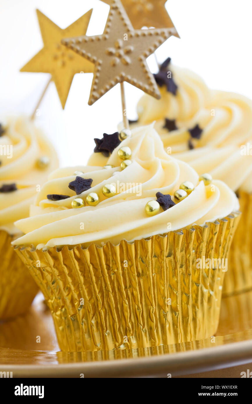 Cupcakes decorated with chocolate stars and golden dragees Stock Photo