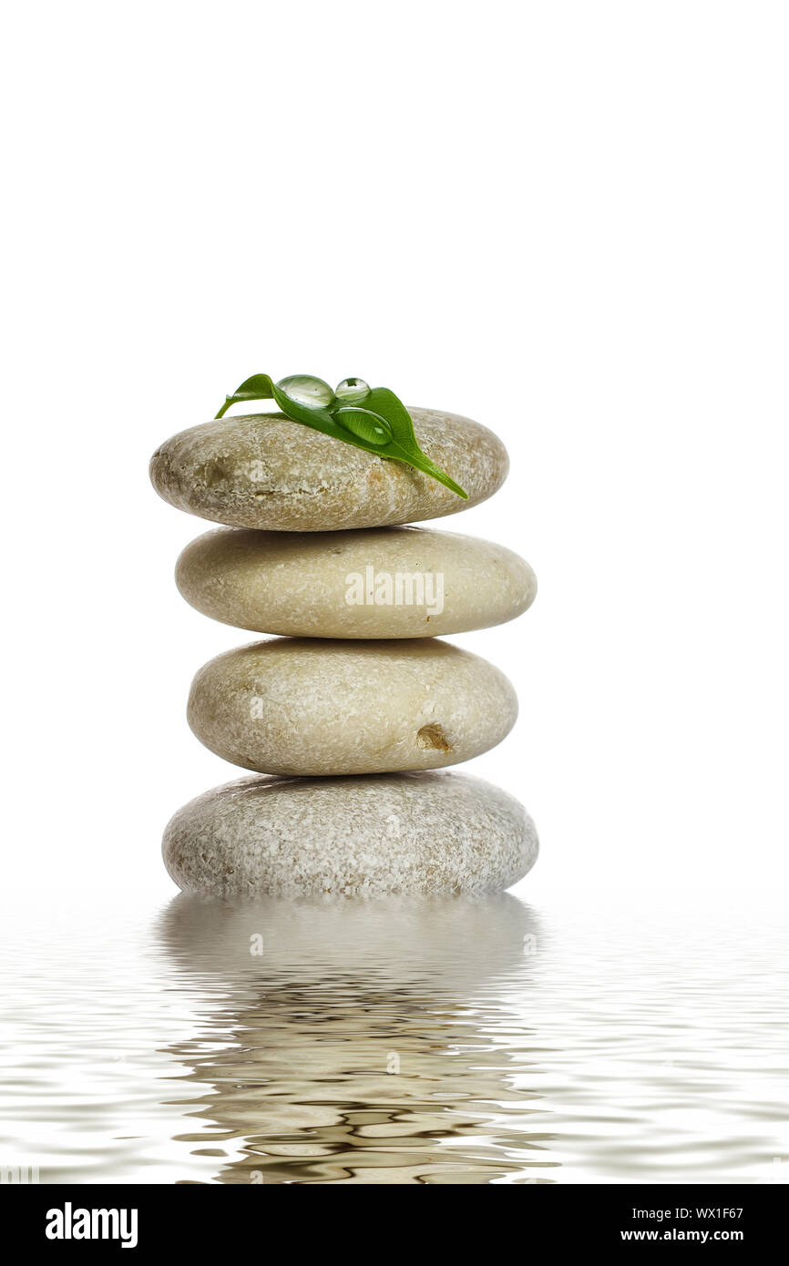 Spa stones and green leaf, isolated on white background Stock Photo - Alamy