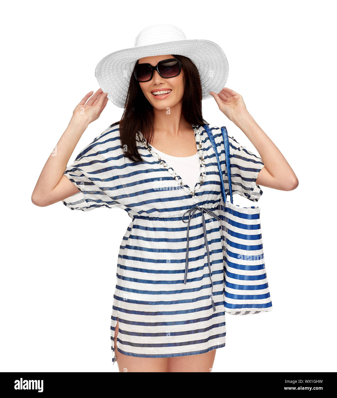 young woman in striped tunic and sun hat Stock Photo