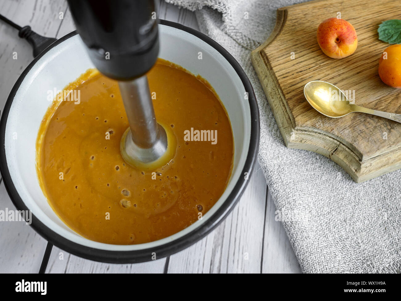 Preparation of apricot smoothie blender. Stock Photo