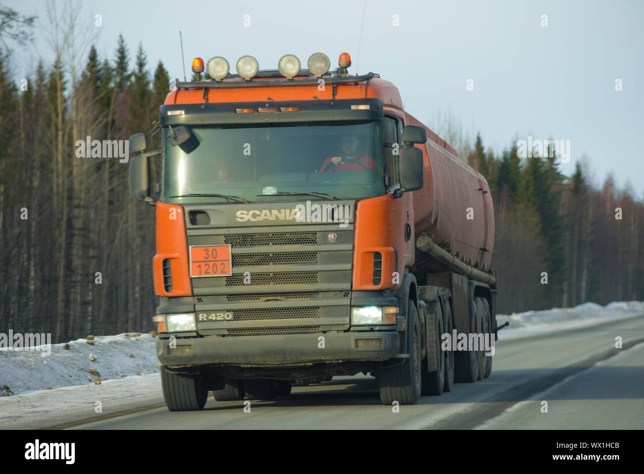 KARELIA, RUSSIA - FEBRUARY 18, 2019: Fuel truck with Scania P420 truck in motion on a winter road close-up Stock Photo