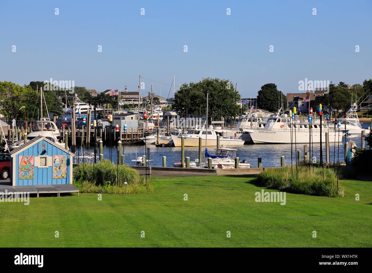 The view of Hyannis harbor with a green grass field in foreground.Hyannis.Massachusetts.USA Stock Photo