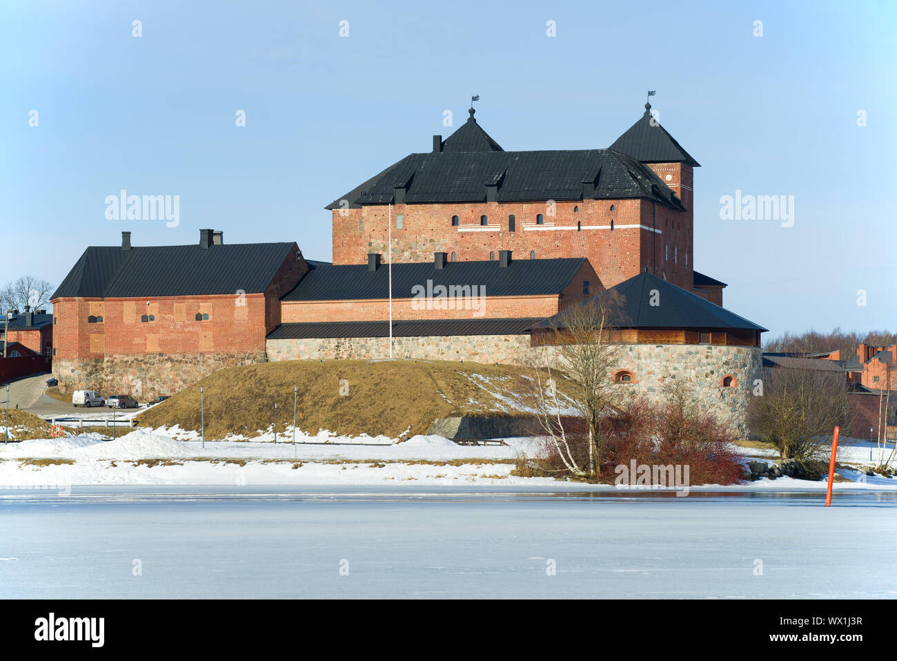 View of an old prison fortress on the shore of Lake Vanajavesi on a sunny March day. Finland, Hameenlinna Stock Photo