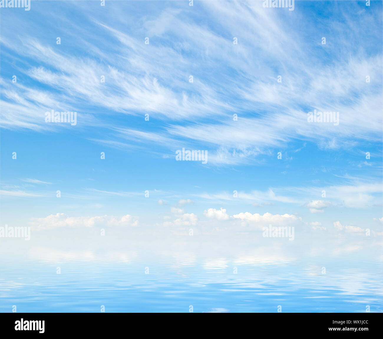 white fluffy clouds with rainbow in the blue sky Stock Photo - Alamy