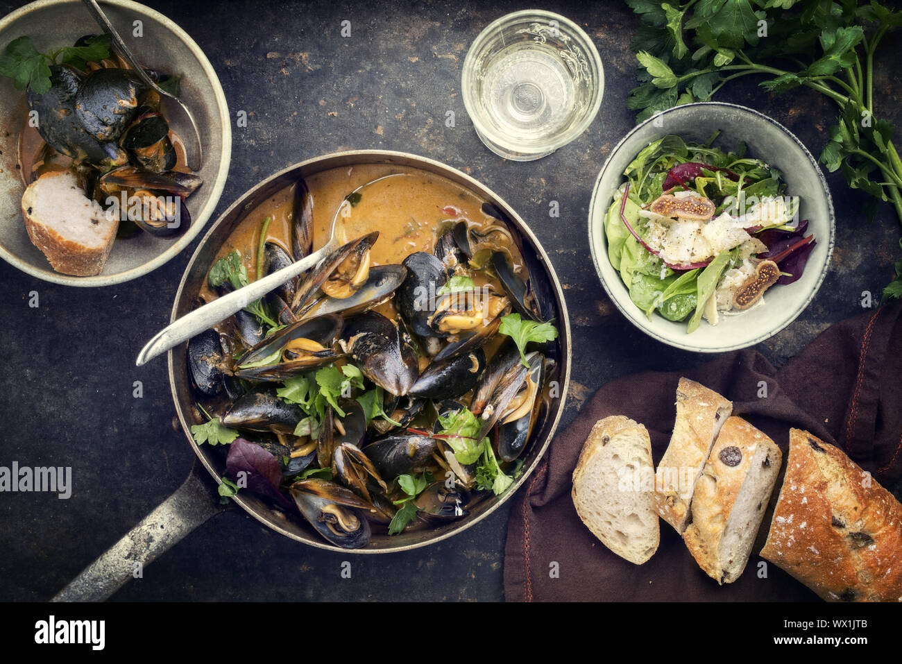 Traditional French blue mussel in bouillabaisse with lettuce and