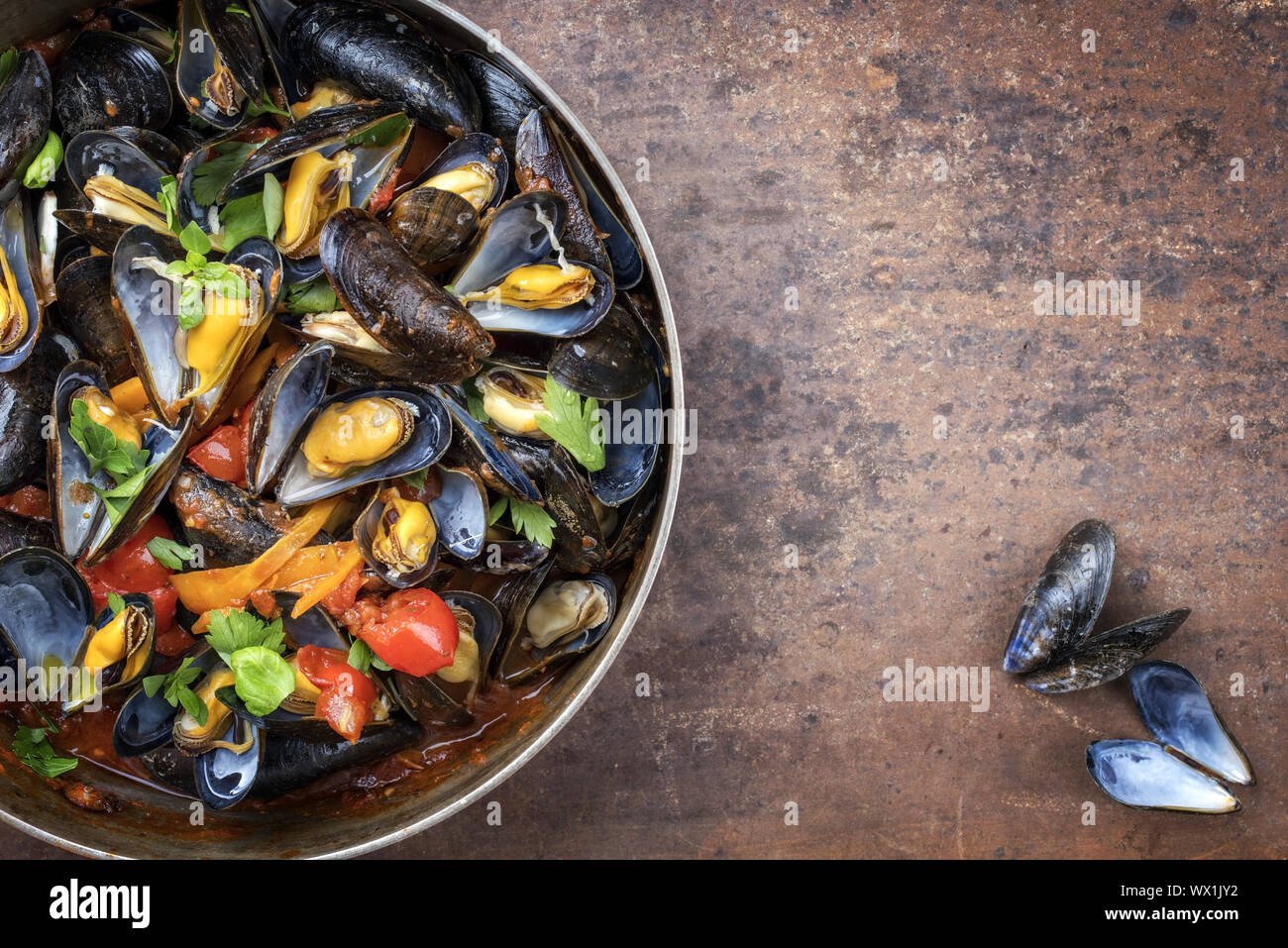 Traditional barbecue Italian blue mussel in red wine sauce as top view