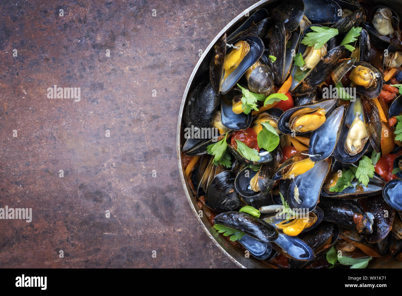 Traditional barbecue Italian blue mussel in red wine sauce as top view