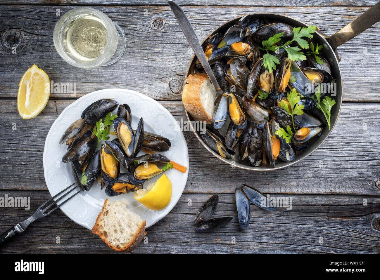 Traditional barbecue Italian blue mussel in white wine as top view in a casserole Stock Photo