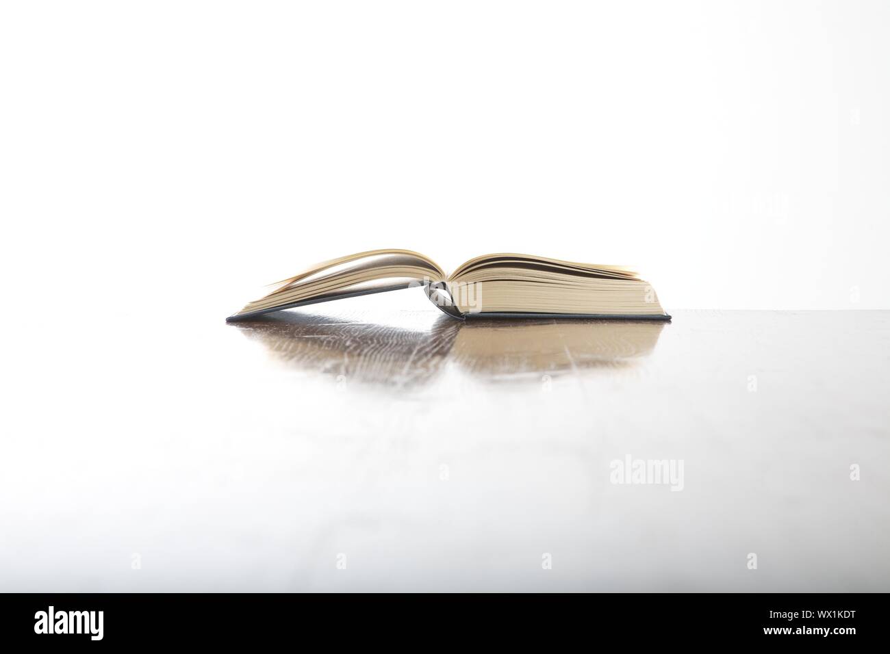 open book side on table and white background Stock Photo - Alamy