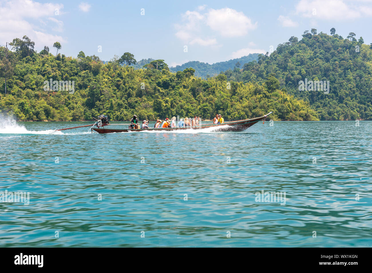 Long-tail boat transport tourists on the Cheow Lan lake in the national park Khao Sok Stock Photo