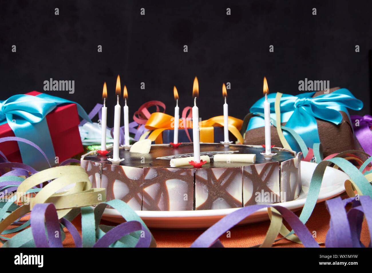 birthday cake with black background on party table Stock Photo - Alamy