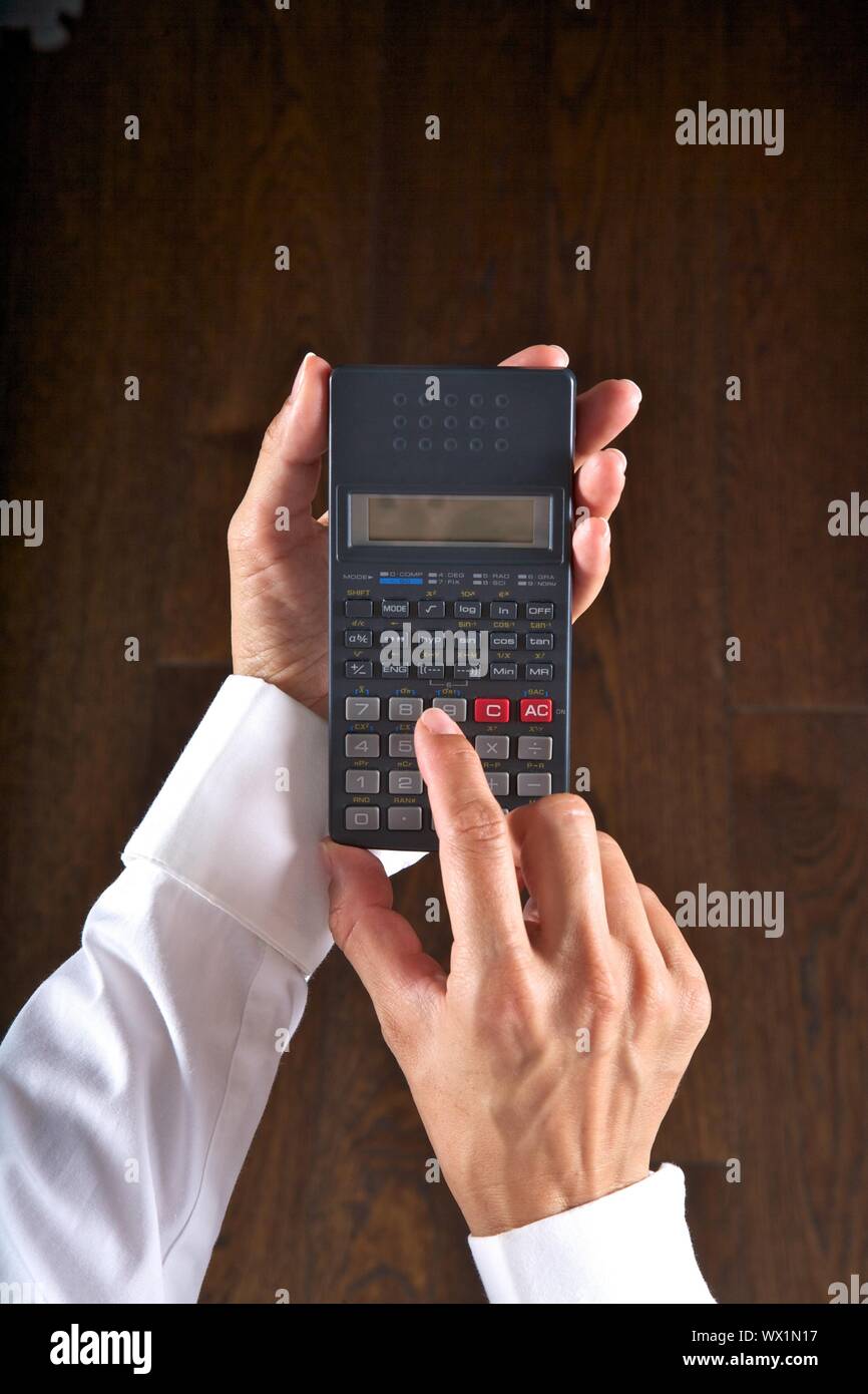 Hand Calculator Math hand detail with a scientific calculator in her hands Stock Photo - Alamy