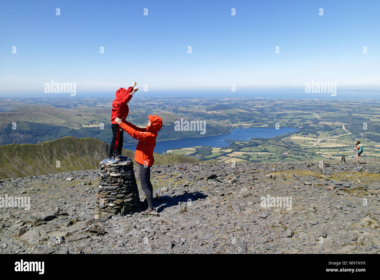 A mother and her son celebrating their arrival on the summit of Skiddaw in the Lake District, Cumbria, UK Stock Photo