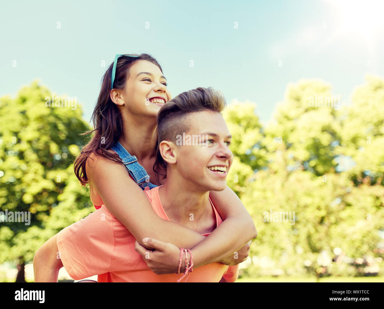 happy teenage couple having fun at summer park Stock Photo - Alamy