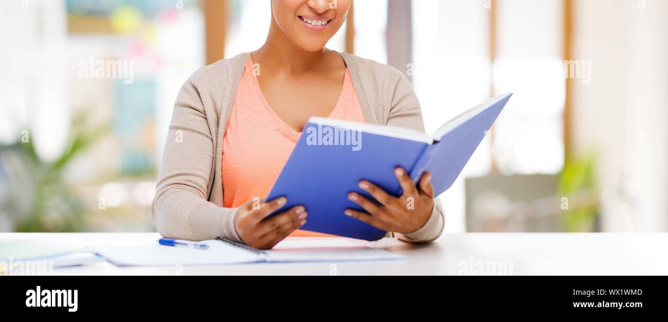 african american female student reading book Stock Photo