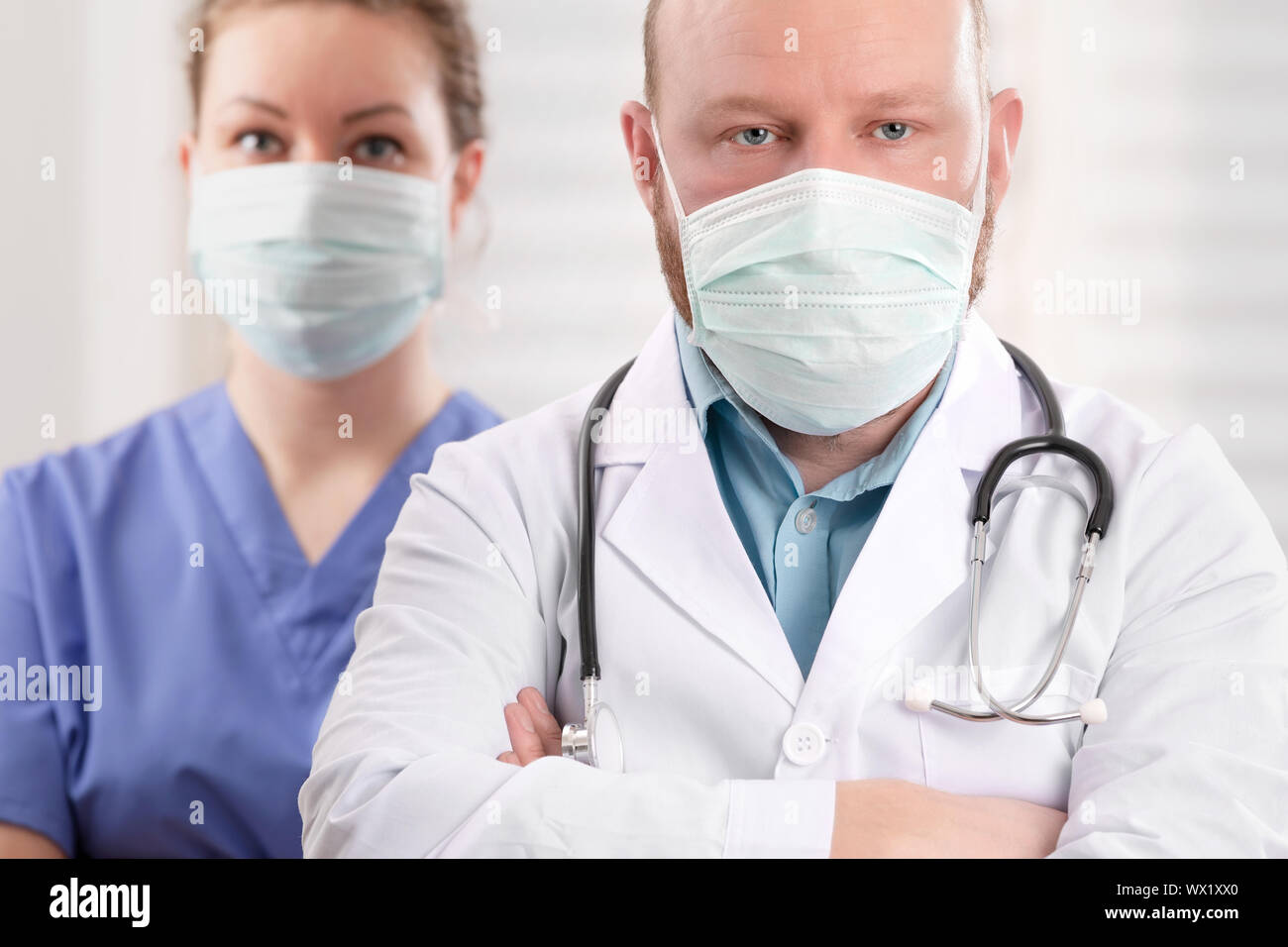 Confident Doctor And Nurse With Arms Crossed In Health Clinic or Hospital Stock Photo