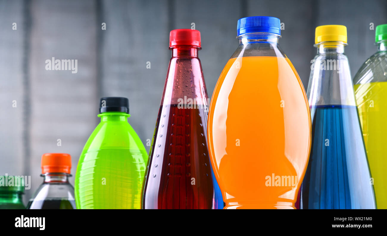 Plastic bottles of assorted carbonated soft drinks in variety of colors. Stock Photo