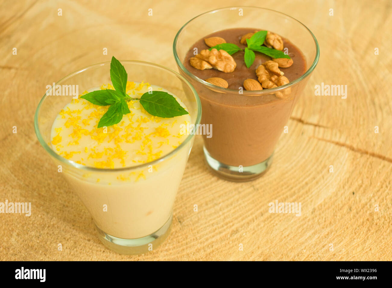 Dessert chocolate pudding with nuts and vanilla pudding with lemon ...