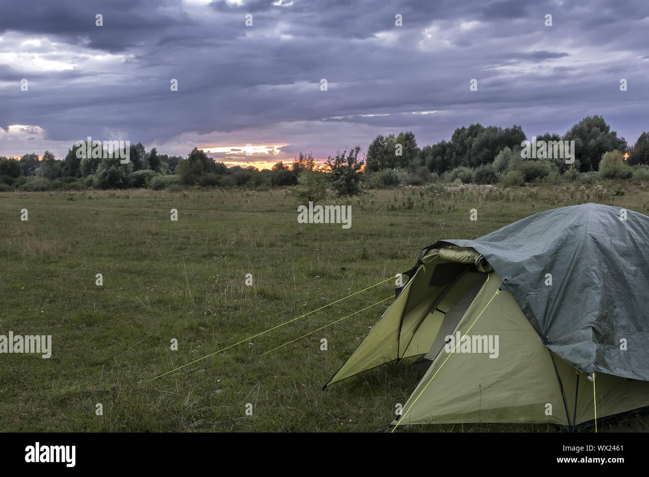 Tourist tent in the meadow in the evening Stock Photo - Alamy