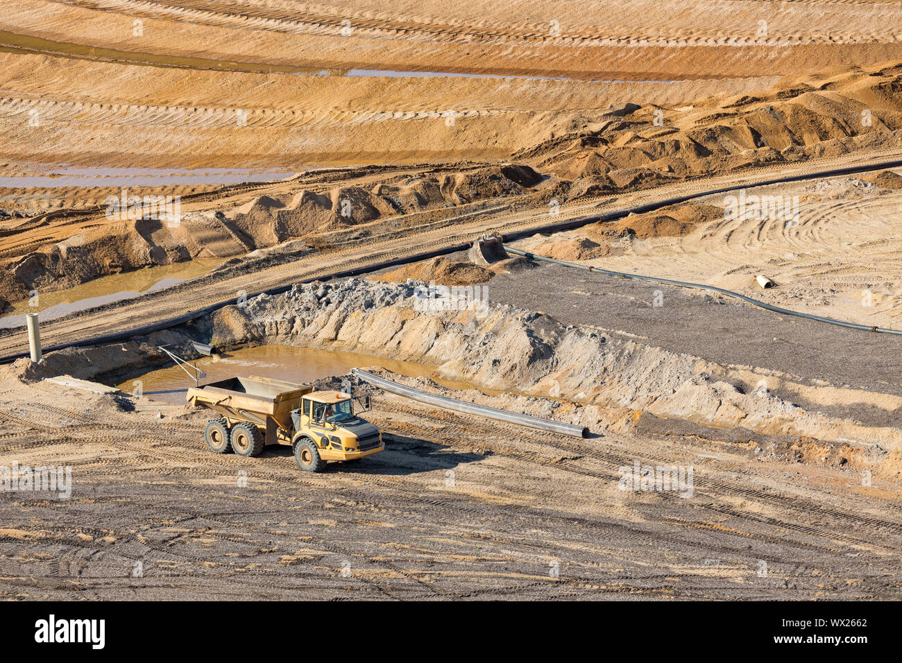 Tipping trailer in brown coal open pit landscape in Germany, Stock Photo
