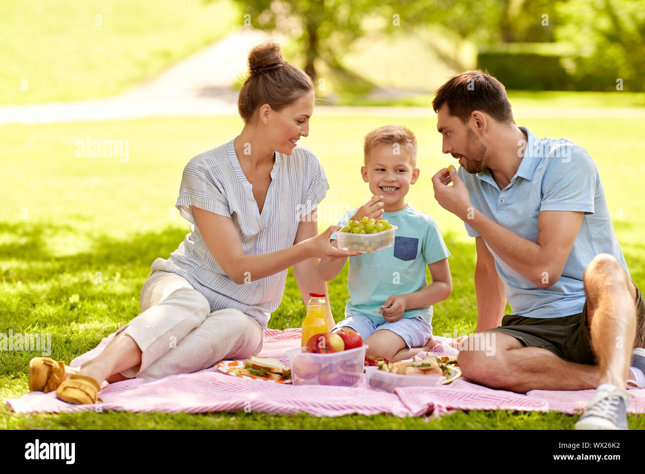 happy family having picnic at summer park Stock Photo