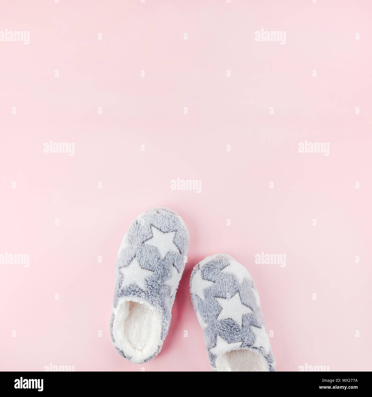 Sleep. Soft fluffy slippers on pink background. Creative conceptual top view flat lay in minimal style. Rest, good night, insomnia, relaxation, tired, Stock Photo