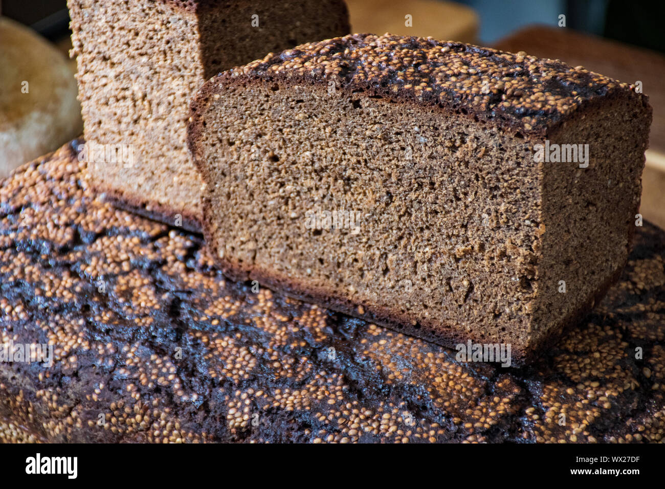 Homemade black rye cereal bread with hemp seeds in a traditional street
