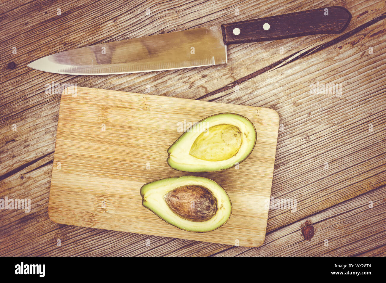 Avocado, cut into avocados, in half, healthy food, cooking, cutting board, Spanish product Stock Photo