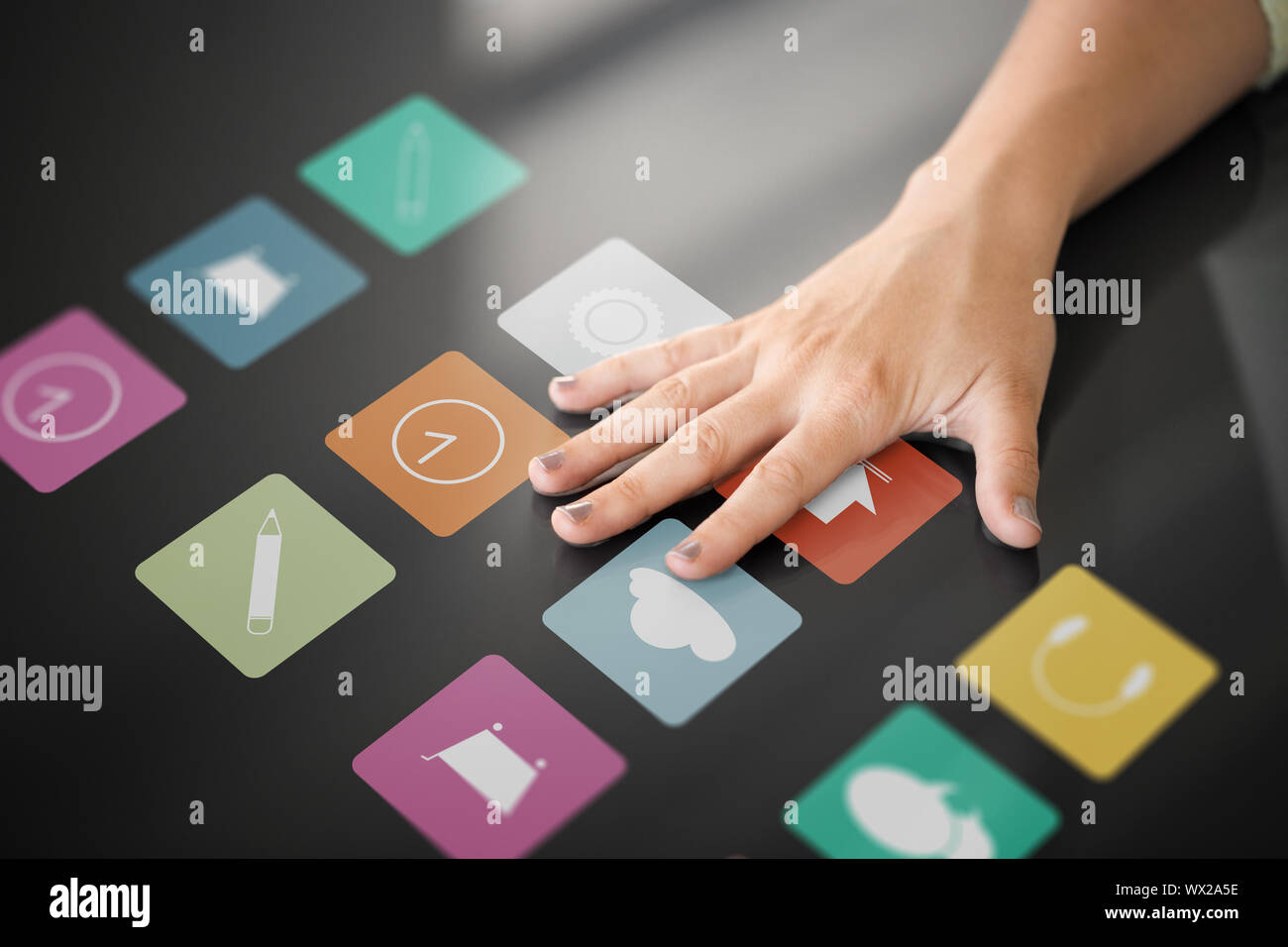 hand using interactive panel with app icons on it Stock Photo