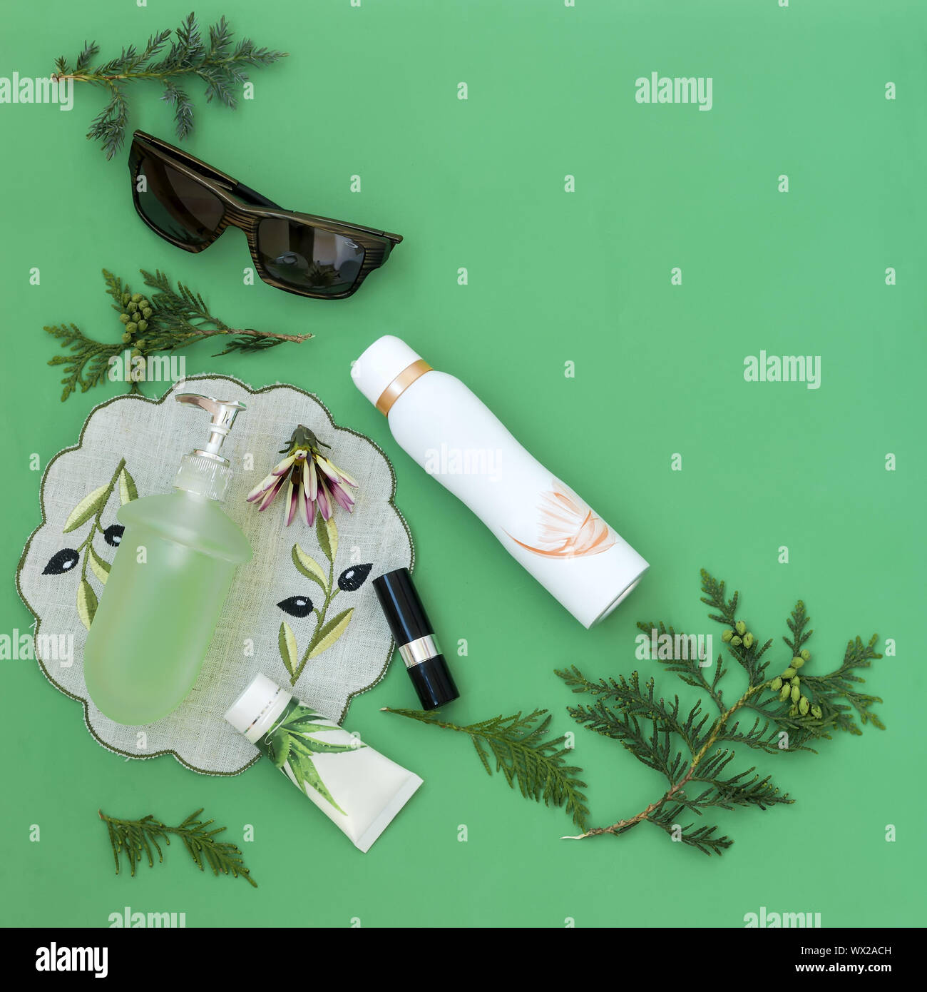 Cosmetics items on a light green background. Stock Photo