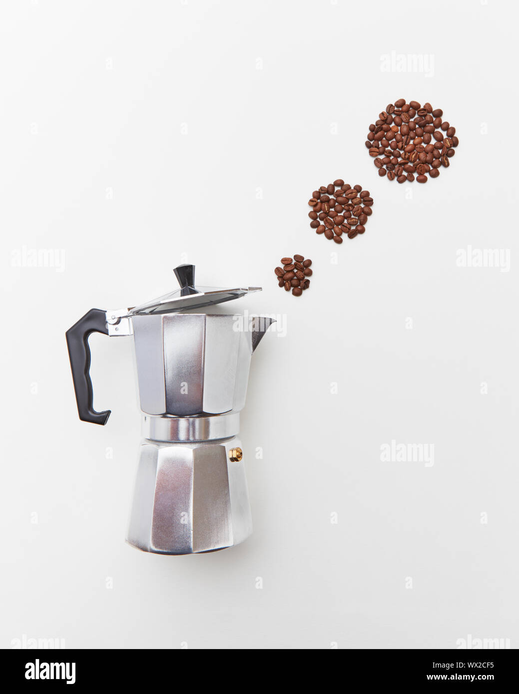 Metal Italian coffee maker with coffee beans in the form of a circles