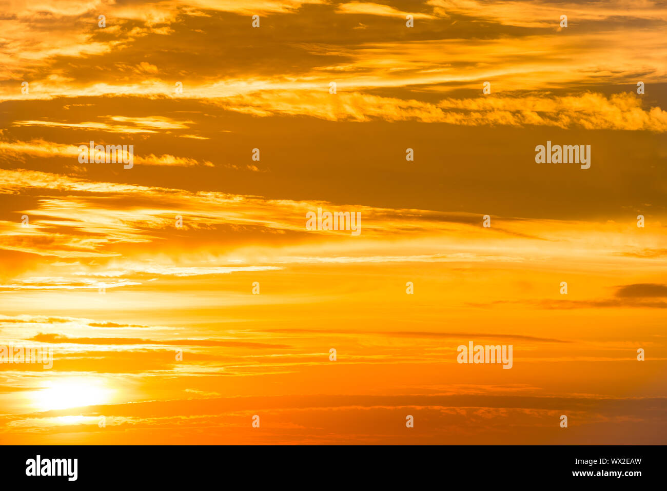 Orange sunset sky with clouds Stock Photo - Alamy