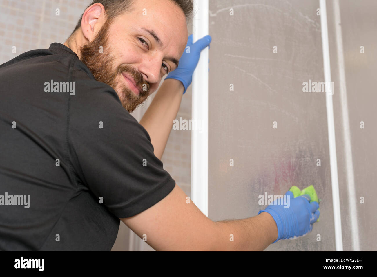 Man cleaning shower cabin Stock Photo Alamy