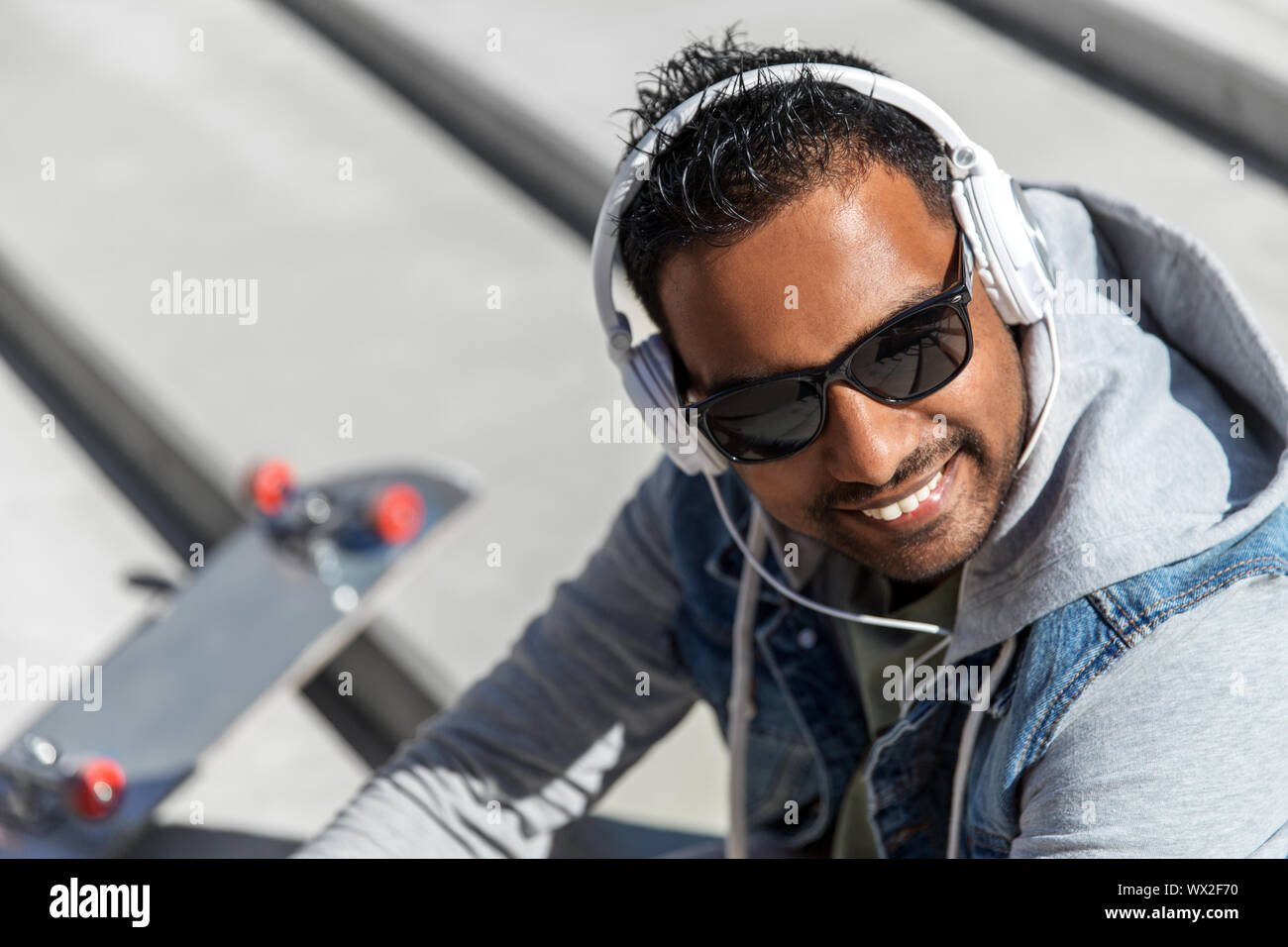 Indian man in headphones hi-res stock photography and images - Alamy